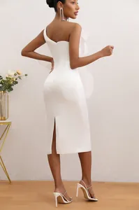 Elegant white one-shoulder midi dress with large ruffle detail shown from the back