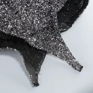 Close-up detail of shimmering silver sequins on a glamorous black cocktail dress