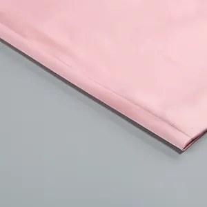 Close-up of the smooth hemline and fine stitching on a pink party dress for women.