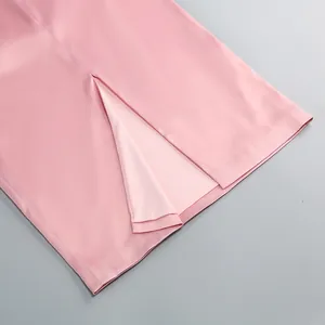 High-quality close-up showing the precise back slit detail of a pink satin party midi dress