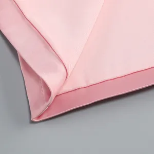 Close-up detail of premium pink knit fabric and neat hemline stitching on dress