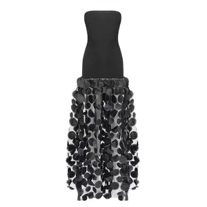 Detailed view of a black strapless tube top dress with 3D floral petal mesh skirt.