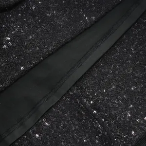 Macro detail of high-quality black sequin fabric and professional hem stitching on party dress