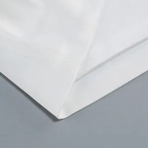 Detailed macro view showing the high-quality white woven fabric texture of this elegant dress