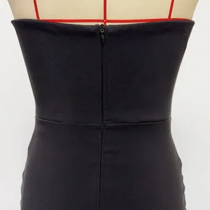 Detailed macro view showing the back invisible zipper on a black strapless tube top dress
