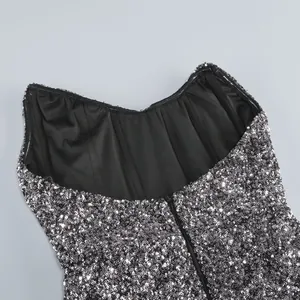 Detail view of the structured bodice and shimmering sequins on a black cocktail dress