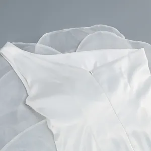 Detail of white one-shoulder party dress with satin fabric and hidden zipper closure