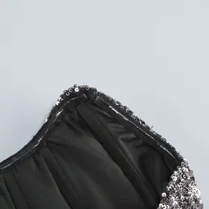 Close-up detail of the inner lining and silver sequins on a strapless party dress.