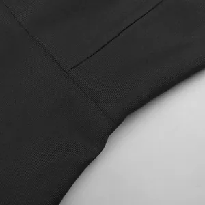 Detailed macro shot showing the fine ribbed texture and seam of the black knit fabric.