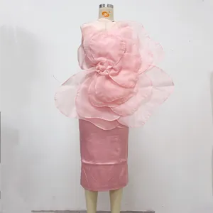 Detailed view of the large pink organza 3D flower on an elegant party midi dress