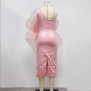 Detailed back view of pink one-shoulder midi dress with oversized ruffle decoration