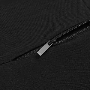Detailed macro view showing the high-quality metal zipper on black textured dress fabric
