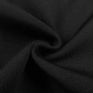 Macro close-up detail of the high-quality black knit fabric showing fine texture and weave