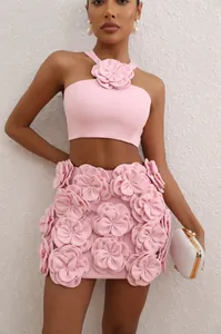 Detailed close-up of pink two-piece set featuring 3D floral halter top and skirt