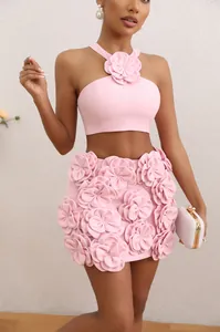 Elegant pink two-piece set featuring a 3D floral halter top and matching mini skirt
