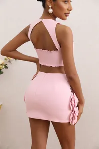 Detailed back view of pink two-piece set featuring halter top and 3D floral accent skirt