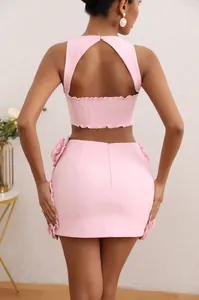 Back view of pink two-piece set featuring 3D flower details and an open back top