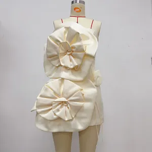 Détail d'une robe bustier élégante crème ornée de grandes fleurs décoratives en 3D
