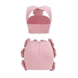 Back view of pink two-piece set with 3D floral accents and smocked halter top.