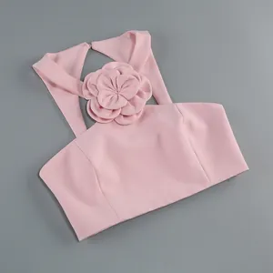 Elegant pink halter top featuring a large 3D flower decoration and open back design