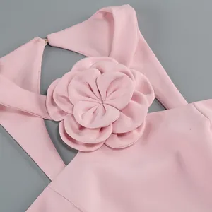Detailed macro view of the elegant 3D fabric flower on a pink halter neck crop top