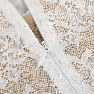 Close-up of white floral lace fabric texture and hidden zipper on an elegant dress.