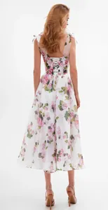 Detailed back view of a white floral midi dress with ties and lace-up design.