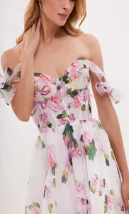 Detailed view of elegant floral print midi dress featuring tie-shoulder and corset bodice