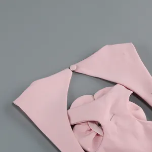 Detail shot of pink halter neck top showing button closure and premium fabric texture.