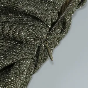 Close-up detail showing the matching hidden zipper on an olive green pleated mesh dress.