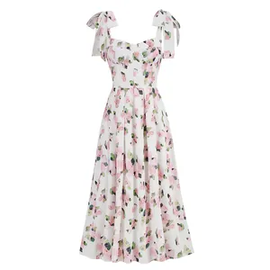 Detail view of white midi dress featuring pink floral print and elegant bow shoulder straps