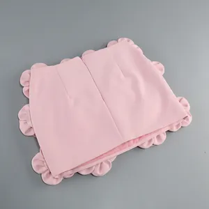 Back view of pink mini skirt featuring unique oversized petal-shaped decorative trim
