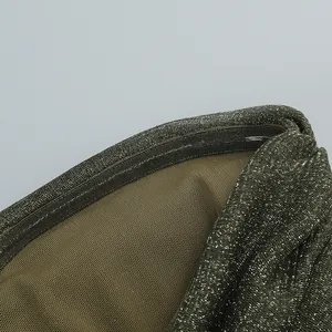 Macro detail of metallic olive-green dress hem showing transparent silicone grip strip