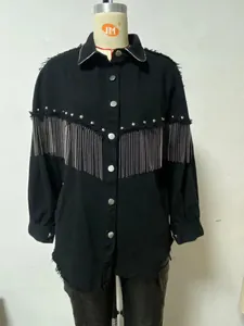 Close-up view of a black denim jacket featuring silver chain fringe and metallic stud detailing