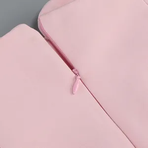 Macro close-up detail of a high-quality invisible zipper on a pink fabric garment.