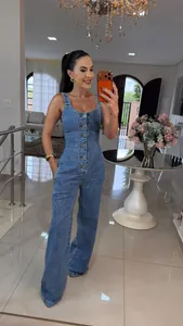 Full-body shot of a slim fit denim jumpsuit with wide leg trousers and button front.