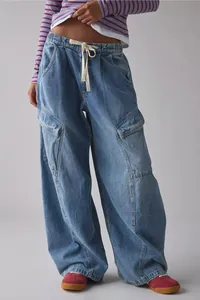 Detailed view of women's relaxed fit wide-leg cargo jeans in washed blue denim