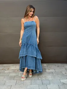 Stylish long denim camisole dress featuring a tiered ruffled hem in a full-body view
