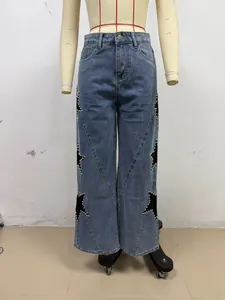 Detailed view of loose straight jeans featuring black star patches and pearl trim