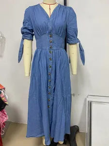 Front view of a blue V-neck button-down denim maxi dress with tie sleeves on a mannequin.
