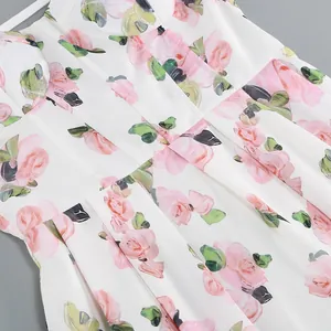 Close-up detail of floral print midi dress with pleated waist and white straps