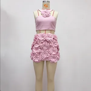 Detailed shot of pink two-piece set featuring handcrafted 3D floral textures and halter top