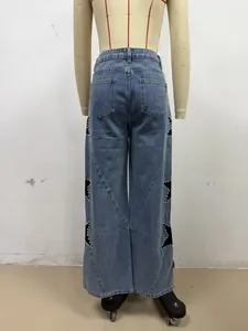 Back view detail of women's baggy straight denim jeans with star patches and pearls.
