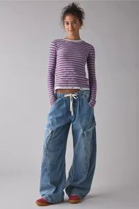 Full-body view of oversized wide-leg women's cargo jeans in vintage blue wash