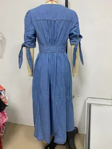 Detail view showing the back of a blue denim maxi dress with bow-tie sleeve accents