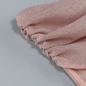 Close-up of elegant pink ruched mesh fabric detail with a subtle metallic sheen