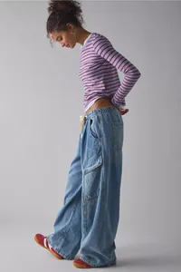Full-length view of women's loose-fit baggy denim jeans with side cargo pockets