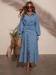Full-body view of a stylish urban denim dress with lantern sleeves and lace-up waist