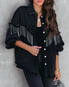 Detail view of heavy-duty denim jacket featuring metal chain fringe and rivet details.