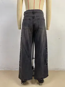Detail view of women's loose black denim jeans with star pearl embellishments